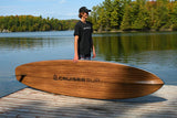 man carrying a Cruiser SUP® stand up paddle board - V-Max Woody 12'0
