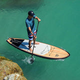 man stand up paddle boarding on Cruiser SUP® Escape LE on a lake