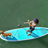 woman stand up paddle boarding with pup on Cruiser SUP® Balance on a lake