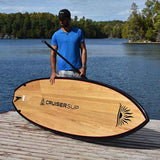 man carrying a Cruiser SUP® stand up paddle board - Escape LE