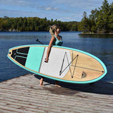 woman carrying a Cruiser SUP® stand up paddle board - Escape LE