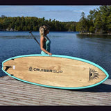 woman carrying a Cruiser SUP® stand up paddle board - Escape LE