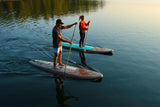 man and woman stand up paddle boarding on Cruiser SUP® Xplorer SE on a lake