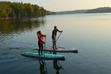 man and woman stand up paddle boarding on Cruiser SUP® Xpedition Woody on a lake