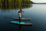 man and woman stand up paddle boarding on Cruiser SUP® Xplorer Woody on a lake