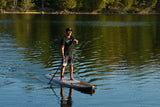 man stand up paddle boarding on Cruiser SUP® V-Max Woody 12'0 on a lake