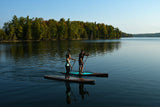 man and woman stand up paddle boarding on Cruiser SUP® V-Max Woody 12'0 on a lake