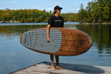 man carrying a Cruiser SUP® stand up paddle board - Xplorer Woody
