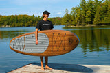 man carrying a Cruiser SUP® stand up paddle board - V-Max Woody 12'0