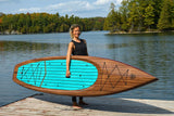 woman carrying a Cruiser SUP® stand up paddle board - V-Max Woody 11'6