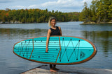 woman carrying a Cruiser SUP® stand up paddle board - Xpedition Woody
