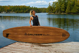 woman carrying a Cruiser SUP® stand up paddle board - Xpedition Woody