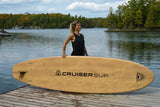 woman carrying a Cruiser SUP® stand up paddle board - Xplorer SE