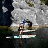 man and woman stand up paddle boarding on Cruiser SUP® Escape LE on a lake